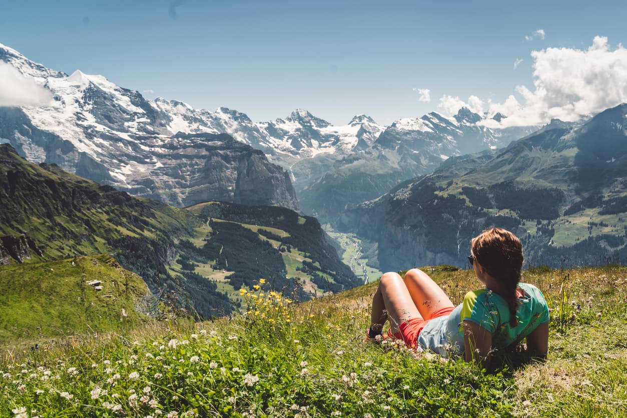 woman-relaxing-meadow-mountains-istock