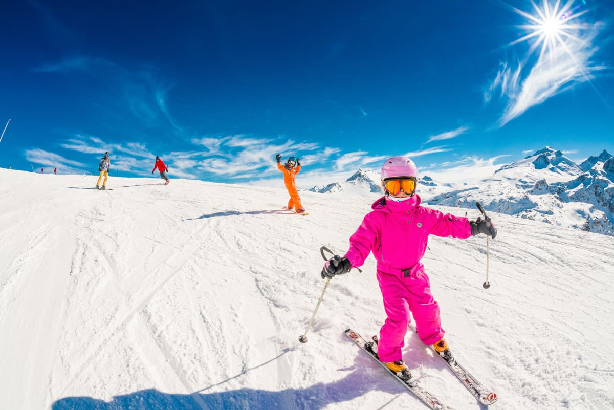 young child learning how to ski with family at Tignes ski resort